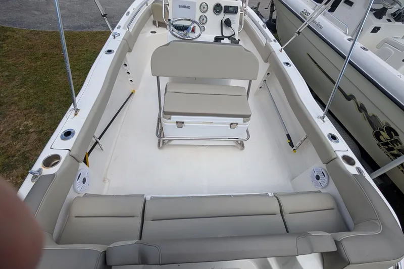Slide: The Image of 2023 Key West 203 FS boat interior with seating and steering console. - 4