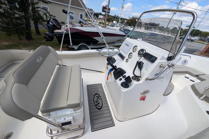 Slide: The Image of 2023 Key West 203 FS boat interior with steering console and seating. - 5