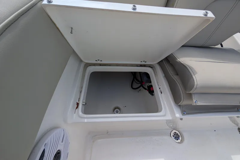 Slide: The Image of Open storage compartment on 2023 Key West 203 FS boat, featuring cushioned seating. - 8