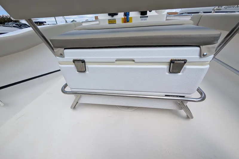 Slide: The Image of 2023 Key West 203 FS boat interior with cushioned cooler seat. - 9