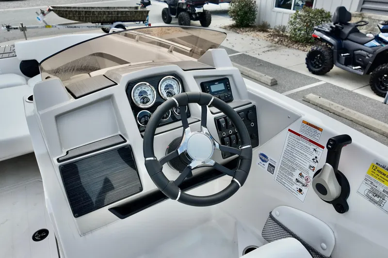 Slide: The Image of 2026 Starcraft SVX 191 OB boat dashboard with steering wheel and control panel. - 4