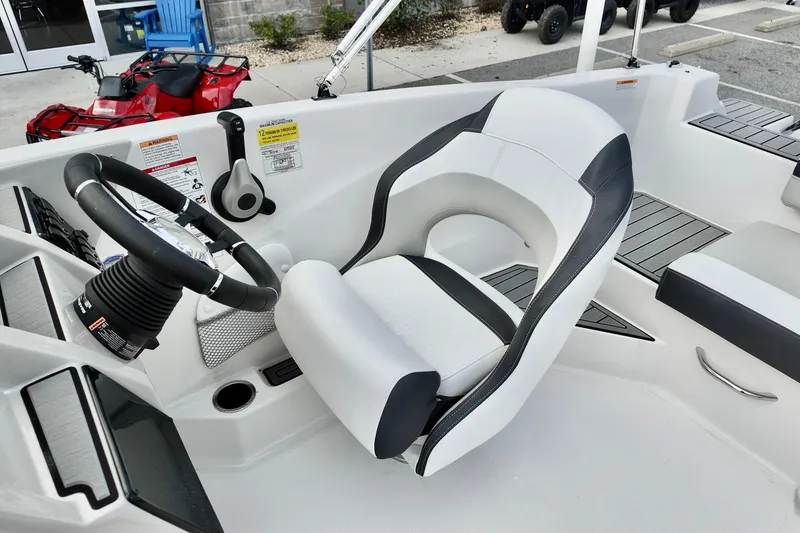 Slide: The Image of 2026 Starcraft SVX 191 OB boat interior with steering wheel and seating. - 5