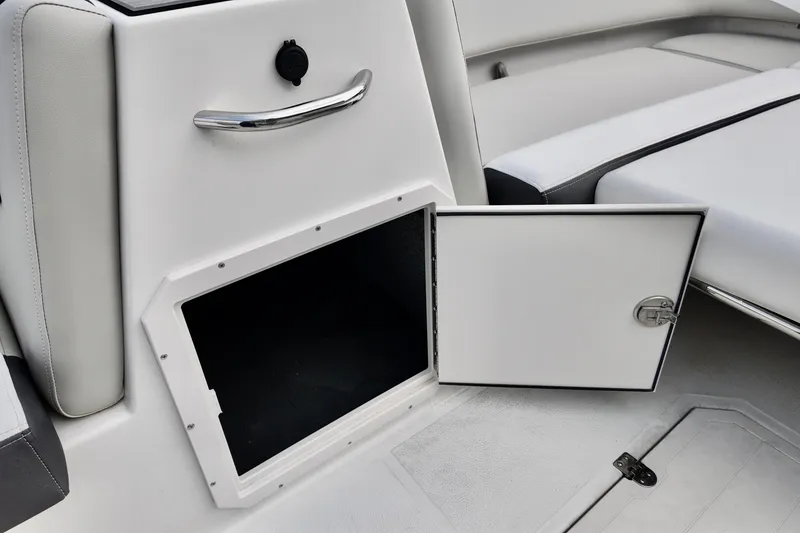 Slide: The Image of 2026 Starcraft SVX 191 OB boat interior storage compartment with open door. - 8