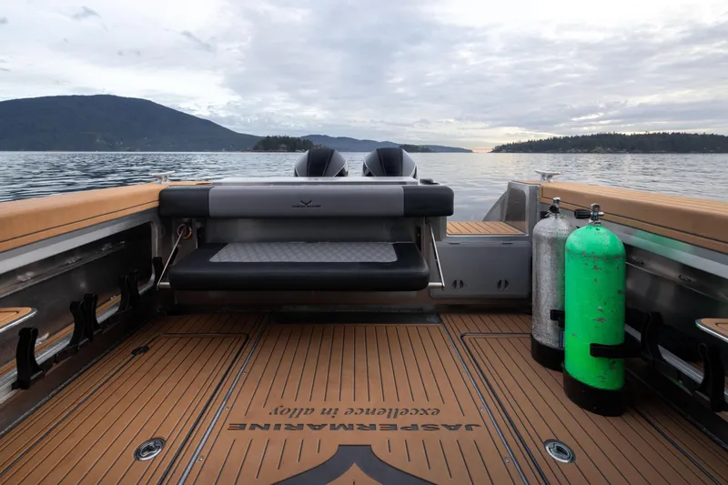 Slide: The Image of 2026 Jasper Marine Defender 22 boat with rooftop tent on serene lake. - 2