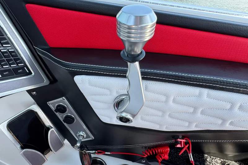 Slide: The Image of 2021 MasterCraft X22 boat interior with control lever and red accents. - 15