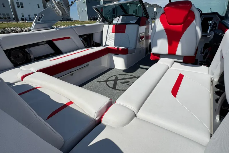 Slide: The Image of 2021 MasterCraft X22 boat interior with red and white seating, modern design. - 20