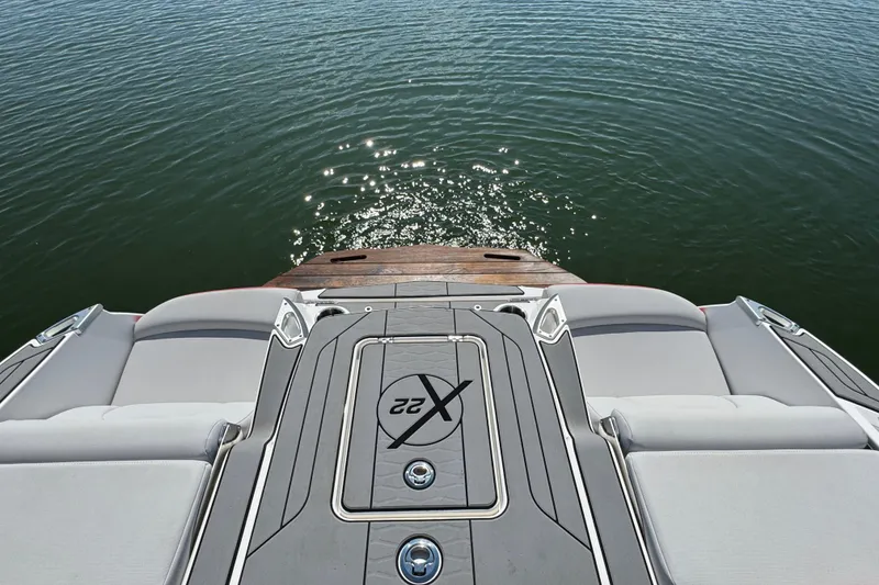 Slide: The Image of 2021 MasterCraft X22 boat deck overlooking sparkling water. - 26