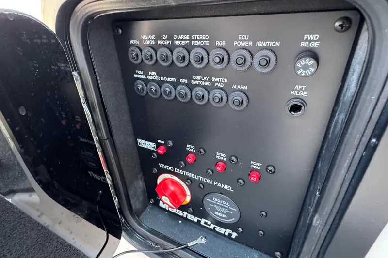 Slide: The Image of 2021 MasterCraft X22 12VDC distribution panel with various switches and controls. - 31