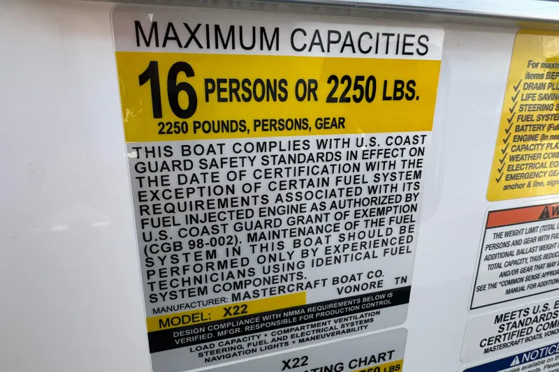 Slide: The Image of 2021 MasterCraft X22 capacity label: 16 persons or 2250 lbs, U.S. Coast Guard compliant. - 33