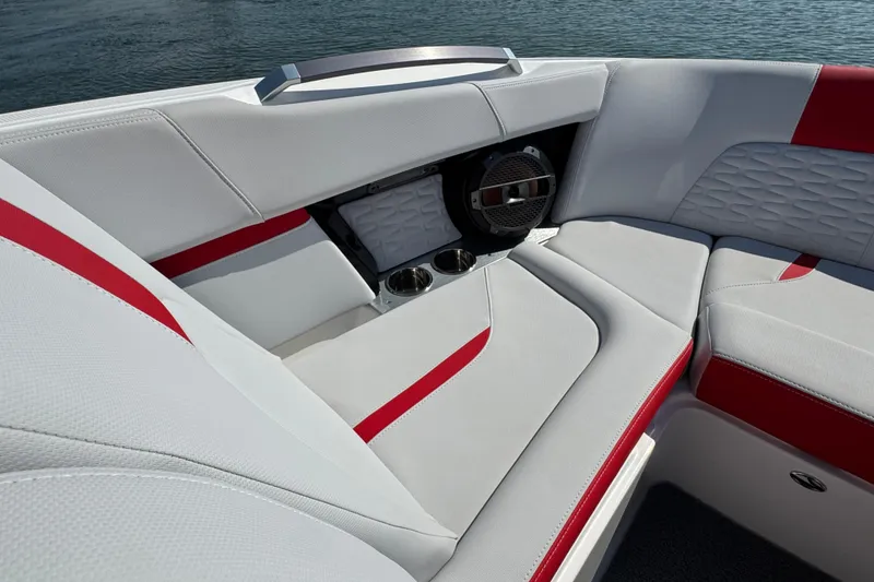Slide: The Image of 2021 MasterCraft X22 boat interior with red and white seating, cup holders, and speaker. - 9
