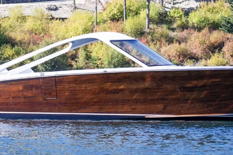 The Image of 2021 StanCraft 390 Hammerhead Coupe on a serene lake with lush greenery. - 1