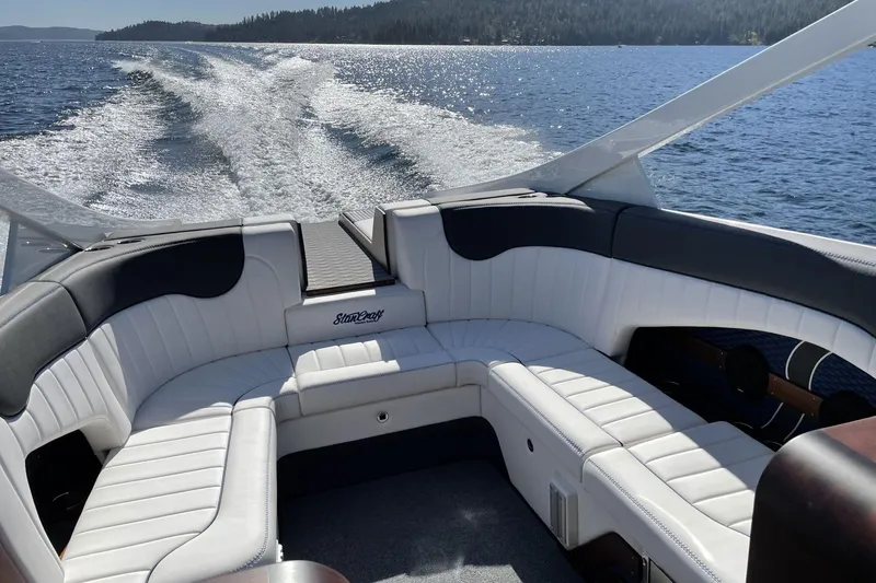 Slide: The Image of 2021 StanCraft 390 Hammerhead Coupe interior with white seating on a lake. - 3
