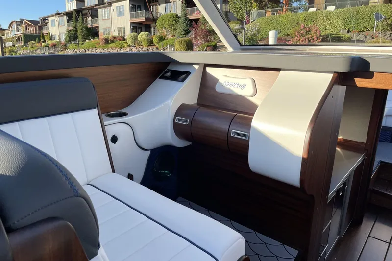 Slide: The Image of Interior of 2021 StanCraft 390 Hammerhead Coupe, featuring elegant wood and leather seating. - 4