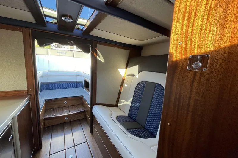 Slide: The Image of Interior of 2021 StanCraft 390 Hammerhead Coupe with luxurious seating and wood finishes. - 5