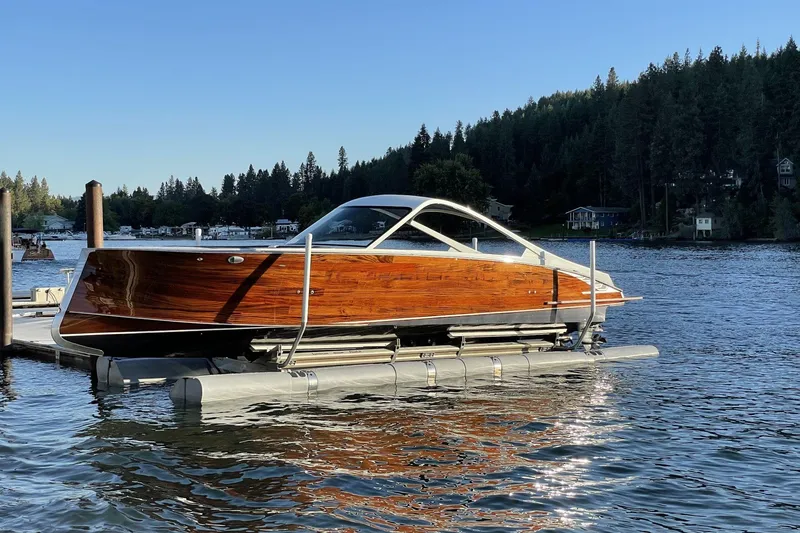 Slide: The Image of 2021 StanCraft 390 Hammerhead Coupe boat on a serene lake with forested background. - 6