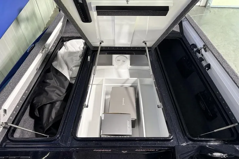 Slide: The Image of Open storage compartments of a 2026 Phoenix 721 ZXL boat, showcasing organized interior space. - 10