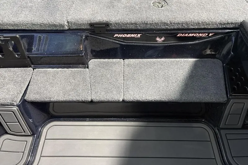 Slide: The Image of 2026 Phoenix 721 ZXL boat interior with gray carpet and storage compartments. - 15