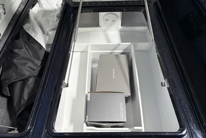 Slide: The Image of Storage compartment of 2026 Phoenix 721 ZXL boat with Garmin equipment boxes. - 16
