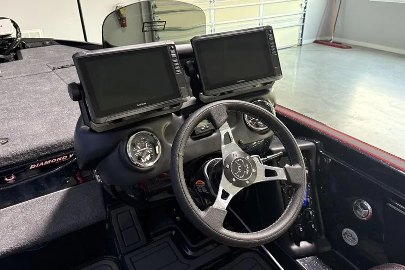 Slide: The Image of 2026 Phoenix 721 ZXL boat dashboard with dual Garmin displays and steering wheel. - 21