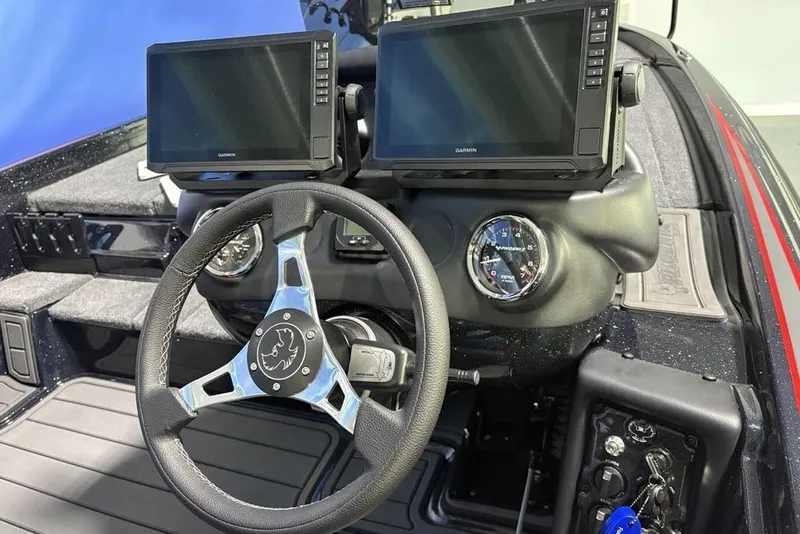 Slide: The Image of 2026 Phoenix 721 ZXL boat dashboard with dual Garmin displays and steering wheel. - 25