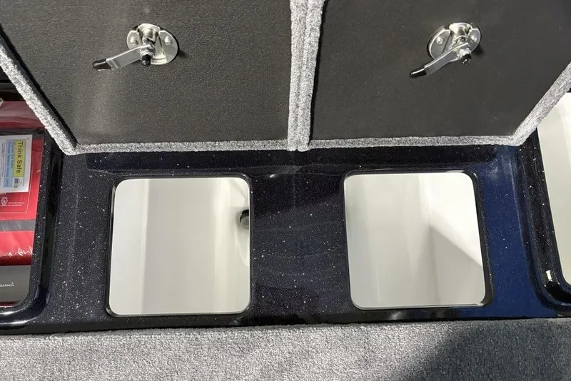 Slide: The Image of 2026 Phoenix 721 ZXL boat storage compartments with secure locks and organized interior. - 28