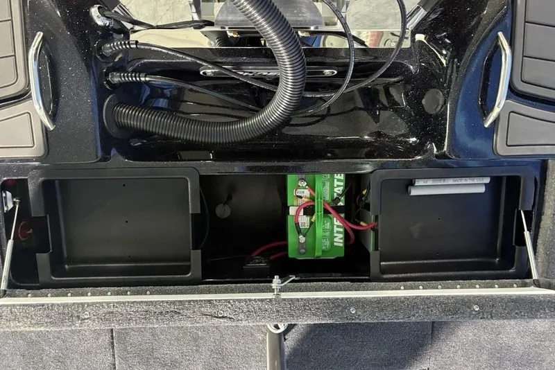 Slide: The Image of 2026 Phoenix 721 ZXL boat battery compartment with wiring and storage spaces. - 29