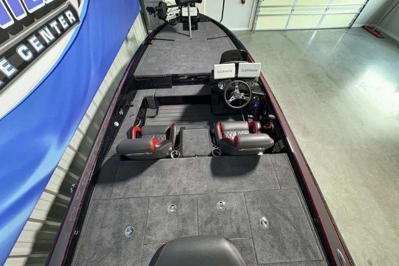 Slide: The Image of 2026 Phoenix 721 ZXL boat interior with Garmin displays and dual seats in a showroom. - 30