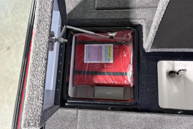 Slide: The Image of Open storage compartment in 2026 Phoenix 721 ZXL boat with safety equipment. - 32