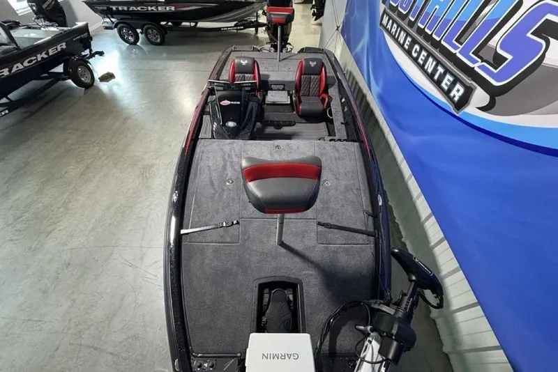 Slide: The Image of 2026 Phoenix 721 ZXL boat interior with red and black seating, displayed at a marine center. - 33