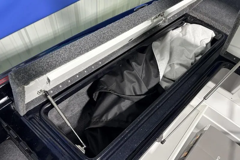 Slide: The Image of Open storage compartment in 2026 Phoenix 721 ZXL boat, featuring interior fabric lining. - 9