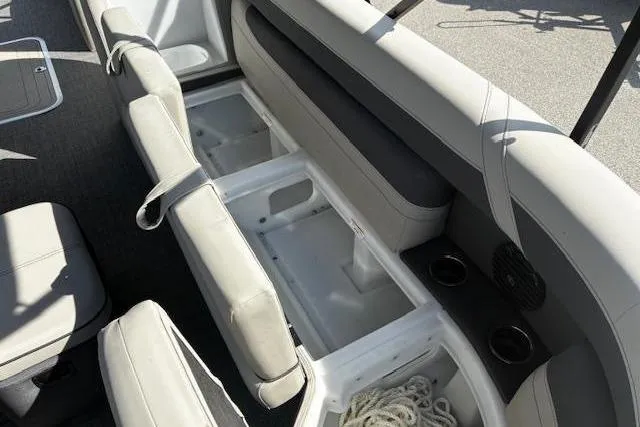 Slide: The Image of 2024 Barletta Cabrio 24CC boat interior with open storage compartments and seating. - 12