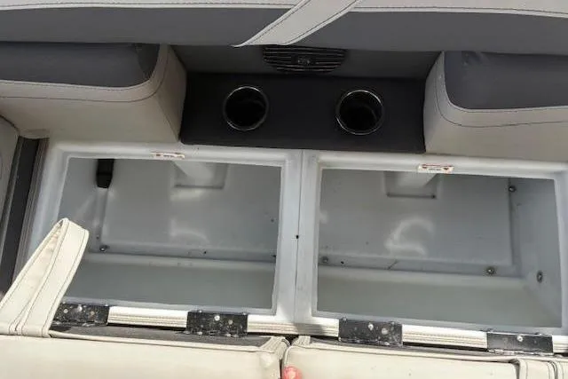 Slide: The Image of Interior storage compartments and cup holders in a 2024 Barletta Cabrio 24CC boat. - 15