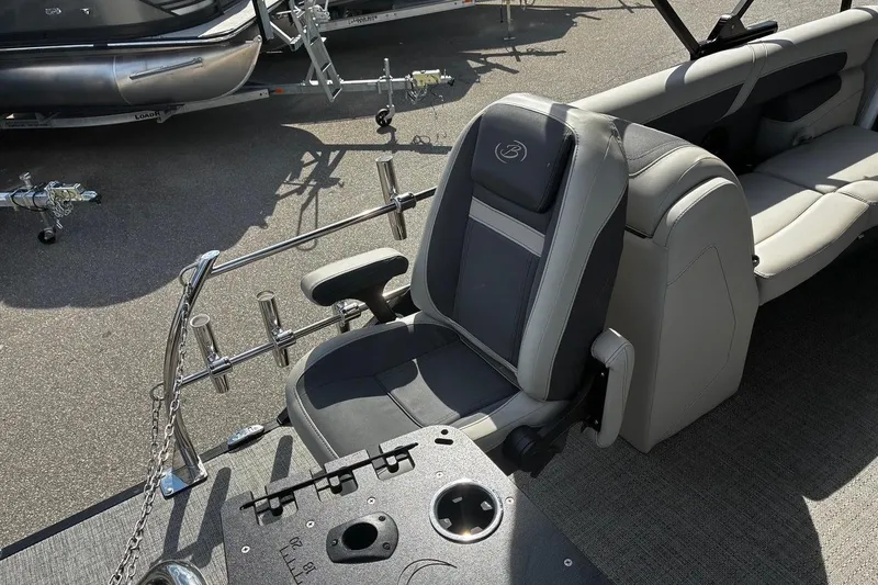 Slide: The Image of 2024 Barletta Cabrio 24CC boat interior with captain's chair and rod holders. - 20