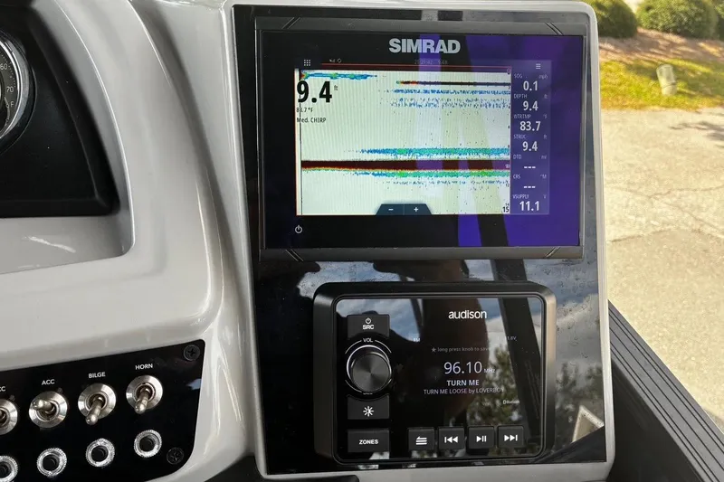Slide: The Image of Simrad display and controls on 2024 Barletta Cabrio 24CC boat dashboard. - 23