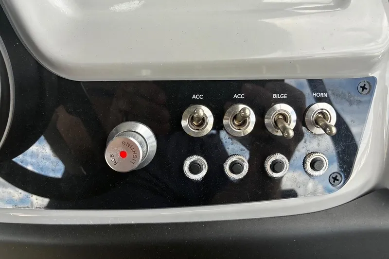 Slide: The Image of Control panel of 2024 Barletta Cabrio 24CC boat with switches and RGB lighting knob. - 24