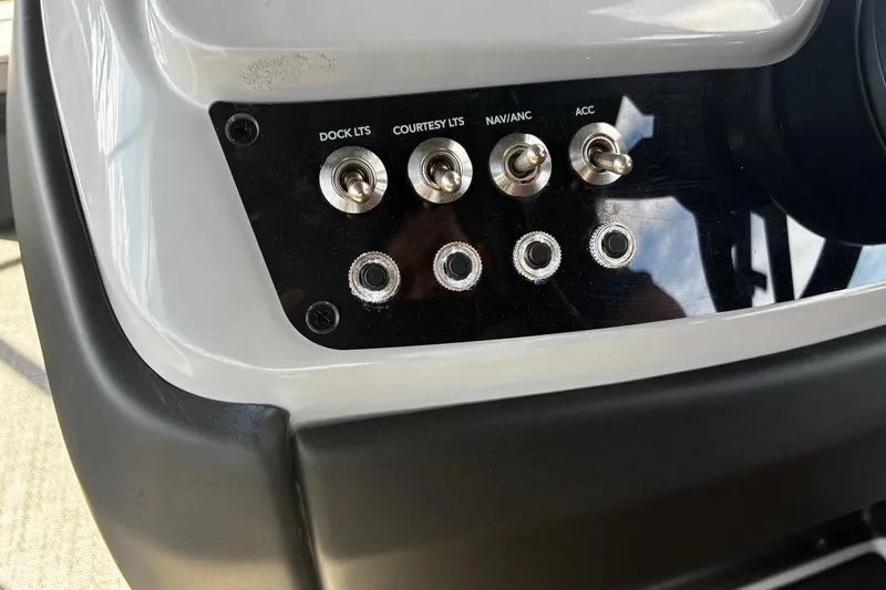Slide: The Image of Control panel of 2024 Barletta Cabrio 24CC boat with switches and ports. - 25