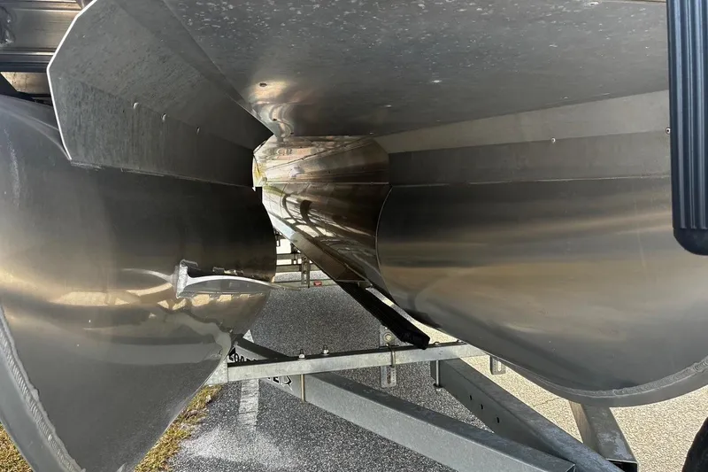 Slide: The Image of 2024 Barletta Cabrio 24CC pontoon boat underside view, showcasing sleek aluminum construction. - 28