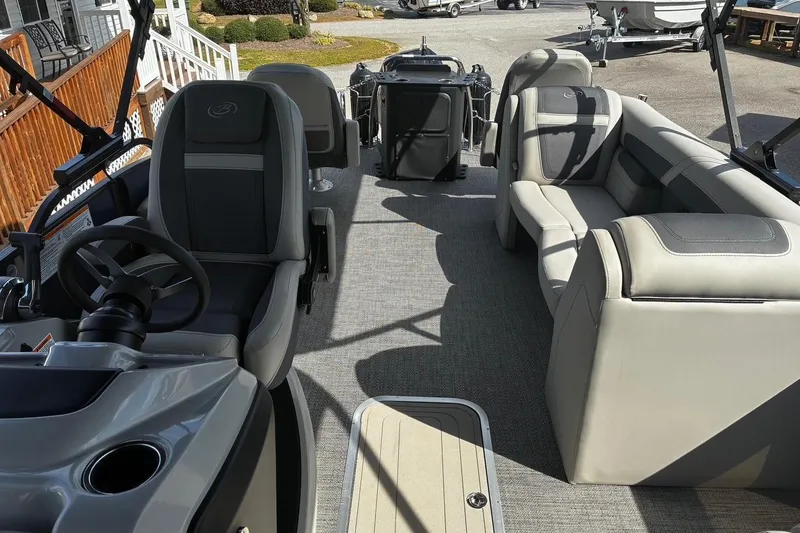 Slide: The Image of 2024 Barletta Cabrio 24CC pontoon boat interior with plush seating and modern helm. - 6
