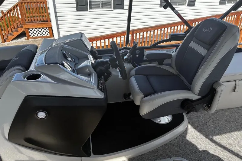 Slide: The Image of 2024 Barletta Cabrio 24CC boat interior with sleek dashboard and comfortable captain's chair. - 8