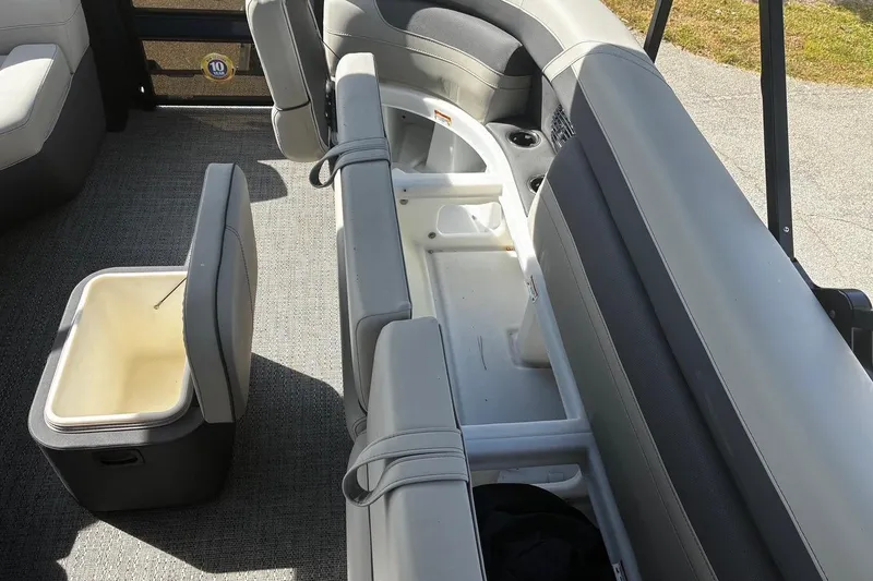 Slide: The Image of 2024 Barletta Cabrio 24CC boat interior with seating and storage compartments. - 9