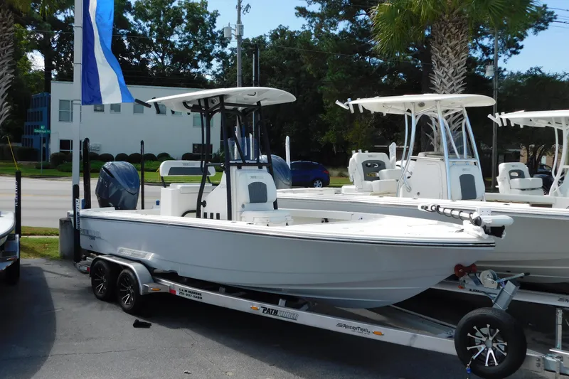 The Image of 2025 Pathfinder 2500 Hybrid boat on trailer, displayed outdoors with blue flag. - 0