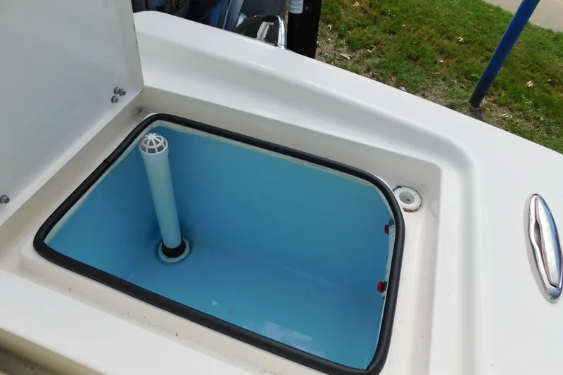 Slide: The Image of Open storage compartment on 2025 Pathfinder 2500 Hybrid boat, featuring a blue interior. - 10