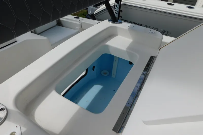 Slide: The Image of 2025 Pathfinder 2500 Hybrid boat interior with open storage compartment. - 13