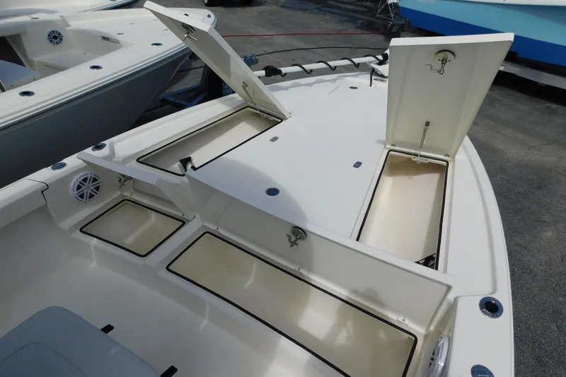 Slide: The Image of 2025 Pathfinder 2500 Hybrid boat with open storage compartments on deck. - 16