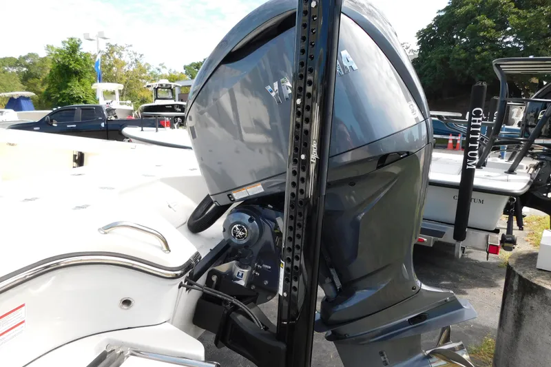 Slide: The Image of 2025 Pathfinder 2500 Hybrid boat with Yamaha outboard motor in a marina setting. - 26