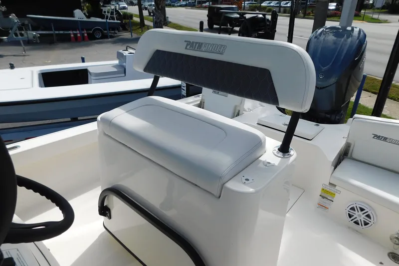 Slide: The Image of 2025 Pathfinder 2500 Hybrid boat interior with cushioned seating and steering wheel. - 5