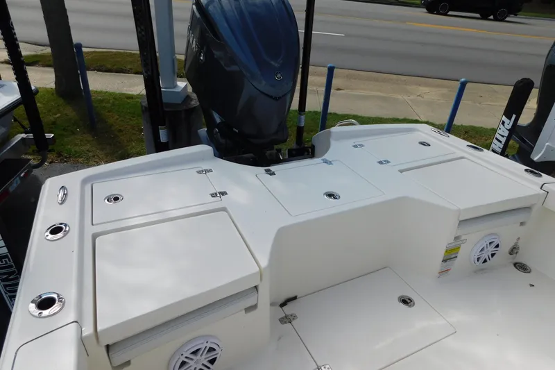 Slide: The Image of 2025 Pathfinder 2500 Hybrid boat deck with storage compartments and outboard motor. - 7