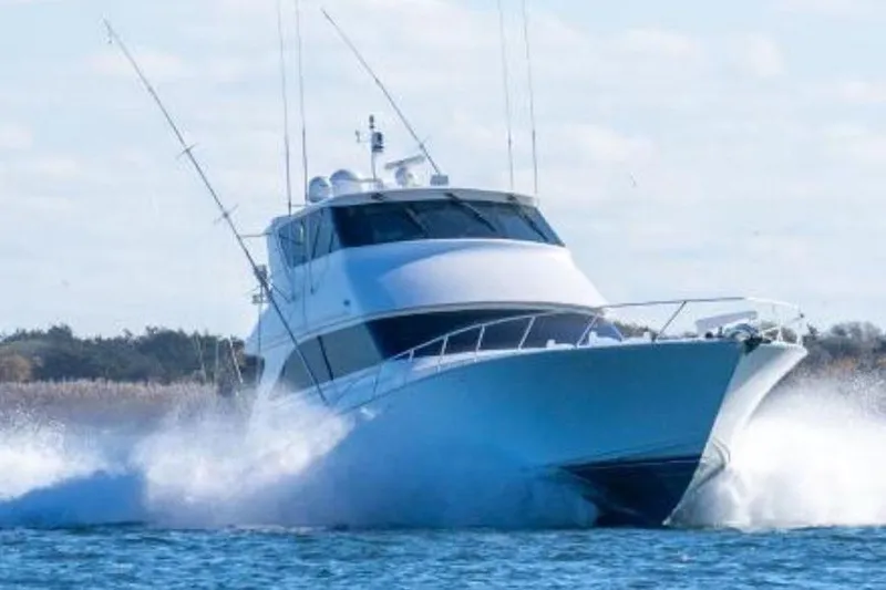 The Image of 2002 Viking 61 Enclosed Bridge yacht cruising on open water. - 0