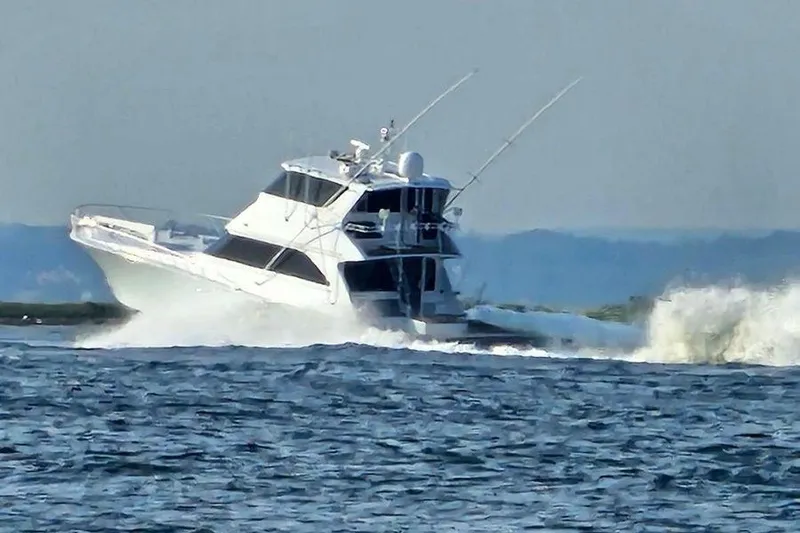 Slide: The Image of 2002 Viking 61 Enclosed Bridge yacht cruising on open water. - 1