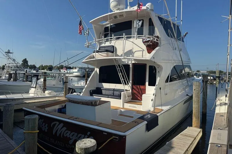 Slide: The Image of 2002 Viking 61 Enclosed Bridge yacht docked at marina under clear blue sky. - 10
